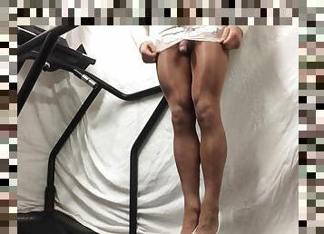 Walking the treadmill in white lacy dress and tan hose .