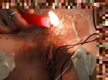 Kinky redhead teen Ava abuses herself with electricity and hot wax
