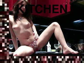 An amazing teen shows her perfect body in the kitchen