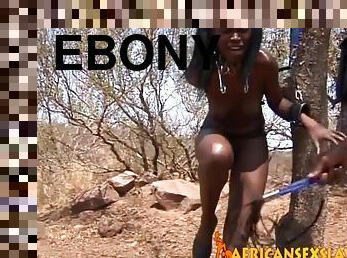 Ebony doll tied up to a tree for some sexy fun