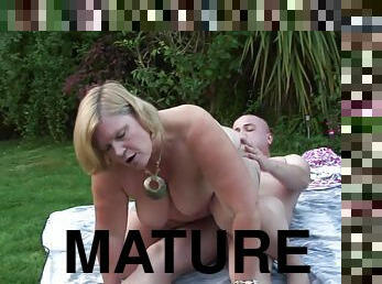 Mature blonde fucking with her husband on the bench in a back yard