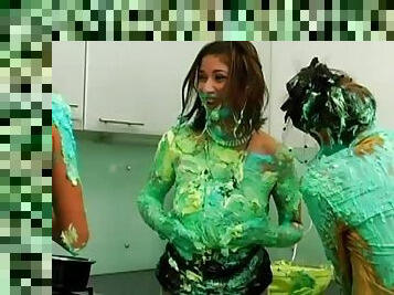 All girl food fight with green frosting covering them