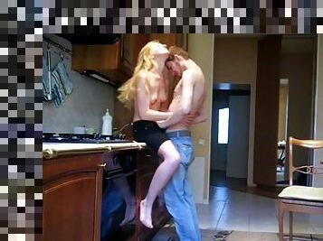 A slim blonde gives head and rides a dick in a kitchen