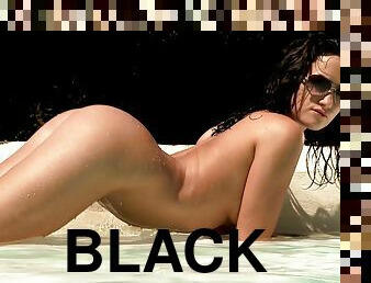 Delicious black-haired slut dildoing her cunt in shallow water