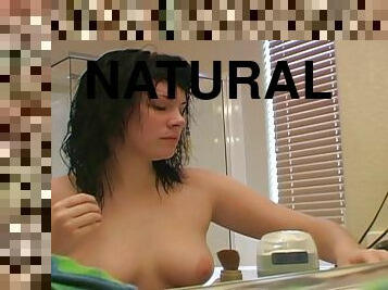 Beautiful brunette with big natural tits blow-drying her hair