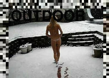 A cute blonde goes out in the snow wearing just her panties