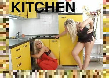 Two beautiful babes hook up and fuck in their kitchen