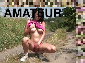 Teen masturbates in the middle of a grassy country road