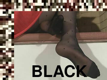 Her sexy feet look amazing in her black polka dot nylons
