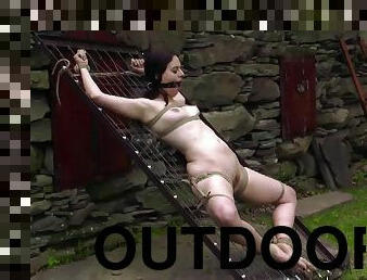 Outdoor shoot showcasing natural tits doll getting tortured in BDSM