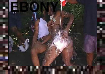 Ebony slut gets naked and fucked by a lot of black men outdoors