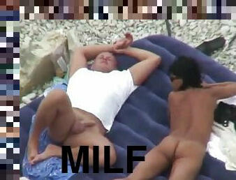 Brunette milf touched on the beach by her hubby