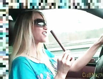 Sexy chick eating beef jerky in the car