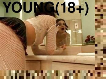 Young chick in white fishnets smokes in bathroom