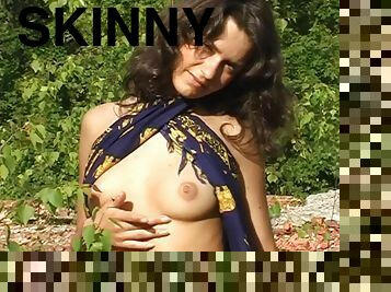 Skinny teen is naked in no time as she strips outdoors