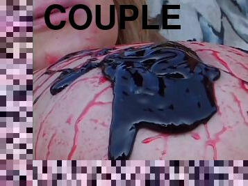 Couple covered in strawberry and chocolate sauce fucks outdoors