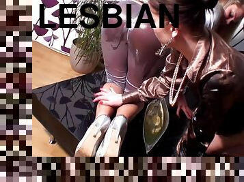 Lesbian blonde and brunette clothed and having slippery fun