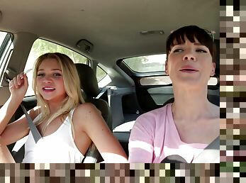Two daring girls have some hot lesbian sex in the back of a car