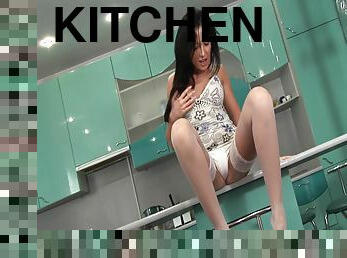 A leggy babe works her ass with a toy in her kitchen