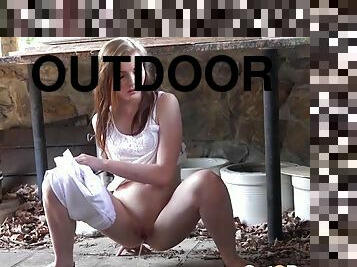 Shaved young chick takes a quick piss outdoors