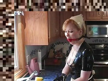 Mistress puts her sub in a latex maid outfit