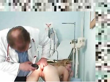 Girl on her knees taking doctor exam