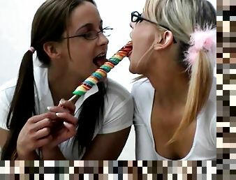 Lesbian teens lick lollipops and fuck their toys passionately