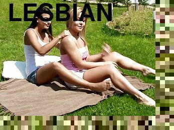 Two well-stacked desirable lesbians make love outdoors