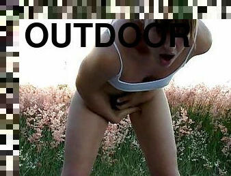 Girl in a field squirts while masturbating