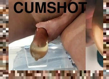 beautiful hard cock pisses in condom and fucks his pee into big cumshot with floating sperm