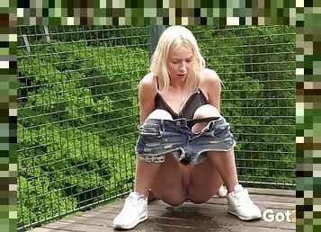 Beauty satin camisole in a girl pissing in public