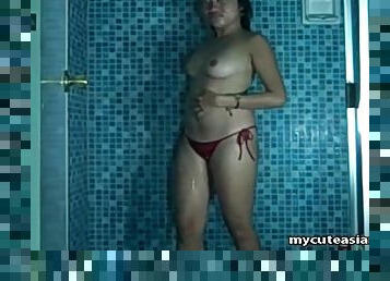 Curvy Asian amateur strips in the shower