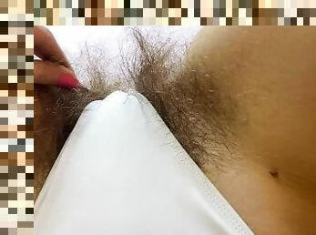 Hairy pussy in white swimsuit closeup