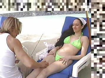 Out by the pool he rubs oil on her then rams his cock in her