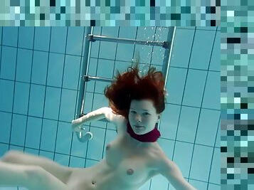 Perfect Russian redhead showing her pussy in the local pool