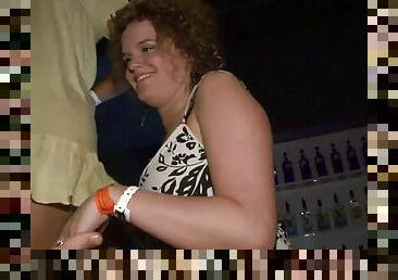 Curly-haired skank flashes her natural tits at a party