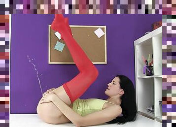 A slim girl in red pantyhose plays with her pussy and pisses