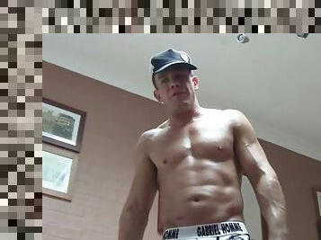 Muscular amateur lubes his body and flexes
