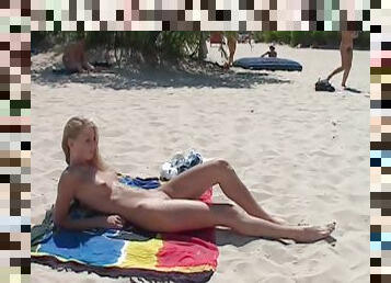 Young nudist friends naked together at the beach 2