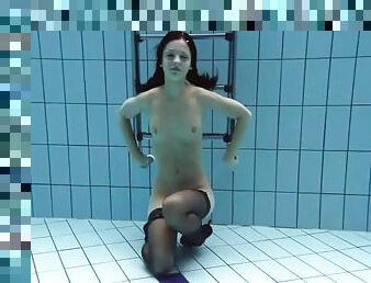 Slim swimming girl in black stockings