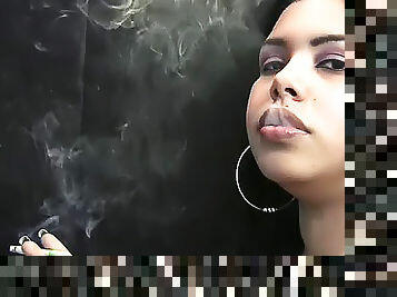 Thick lips girl smokes a cigarette