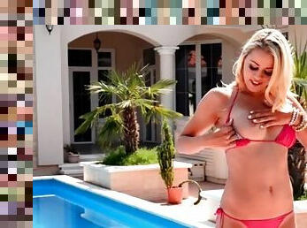 Blonde girl with a perfect bikini body plays outdoors