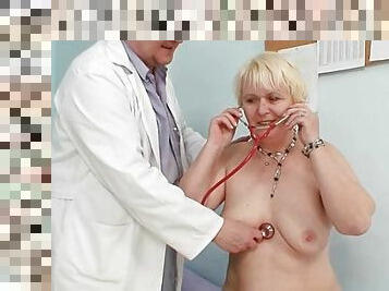 Speculum peers into the pussy of an old lady