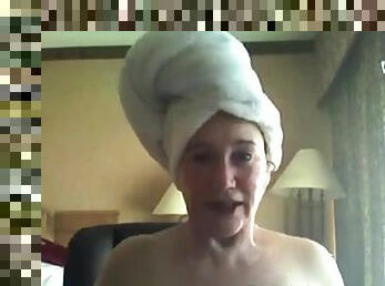 A fresh old woman teases the camera after a shower