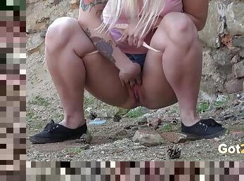 Sexy sleeve tattoo on a girl peeing in public