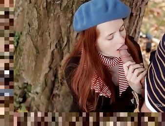 Redhead in winter clothes blows him outdoors