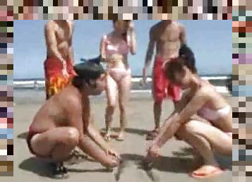 Japanese girls wrestling on the beach