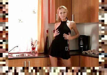 Watch this fabulous babe dressed in black masturbating in her kitchen