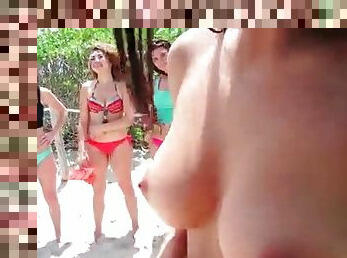 Bikini girls give a blowjob on the beach