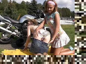 Lesbians ride motorcycles then work that pussy in a field